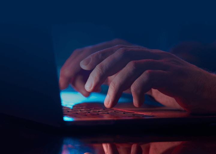 A person types on a laptop as they optimize their Usenet search experience with UsenetServer’s premium browsing and top-rated Usenet features.