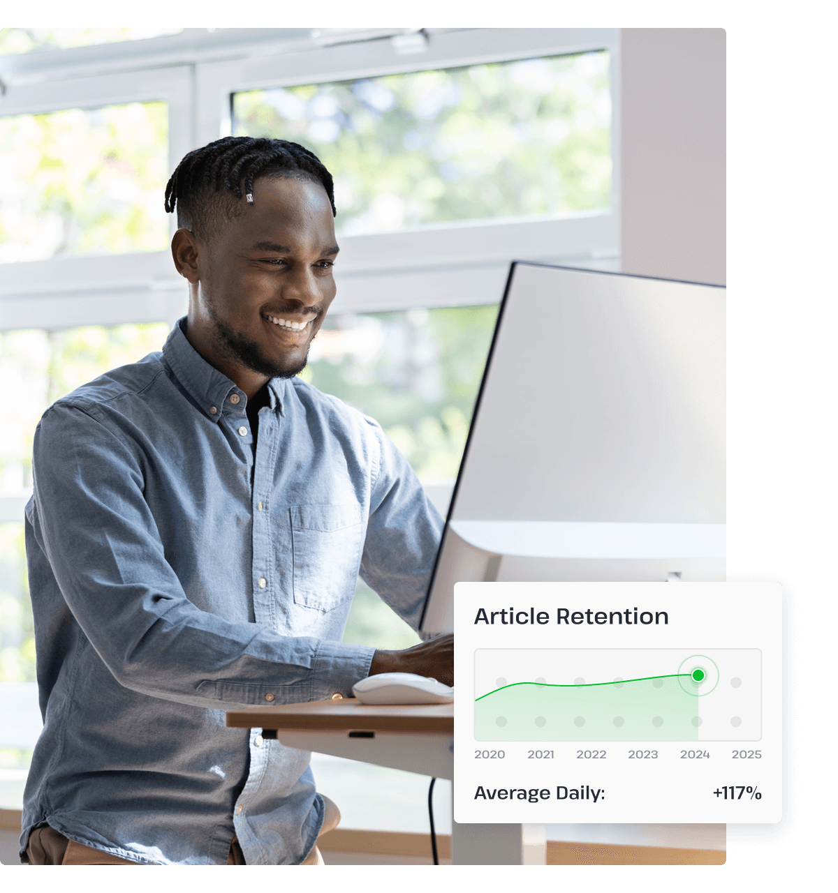A man stands at his desk smiling at his desktop computer next to a pop-up graphic that shows UsenetServer’s article retention increasing over time.